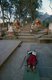 Nepal: Pilgrim prostrating at the lower part of Swayambhunath (Monkey Temple), Kathmandu Valley